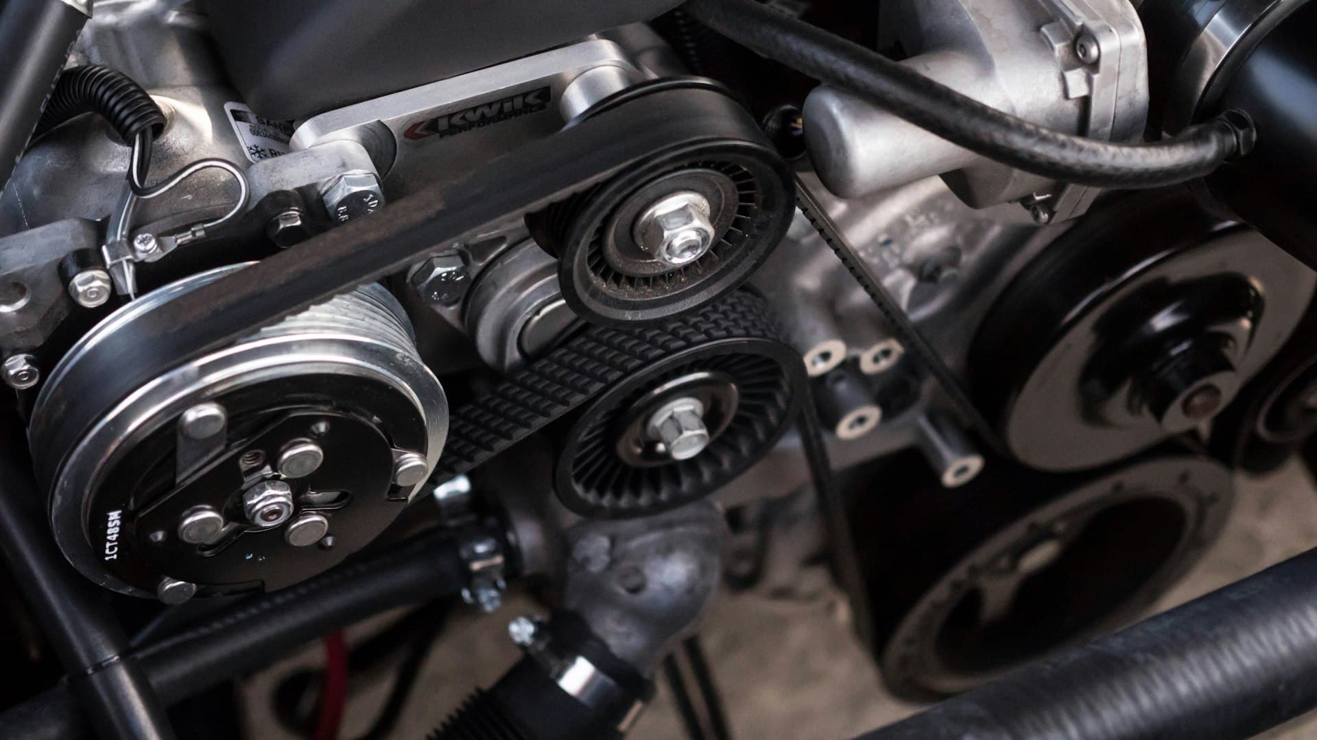 Technician performing oil change and fluid service on a vehicle